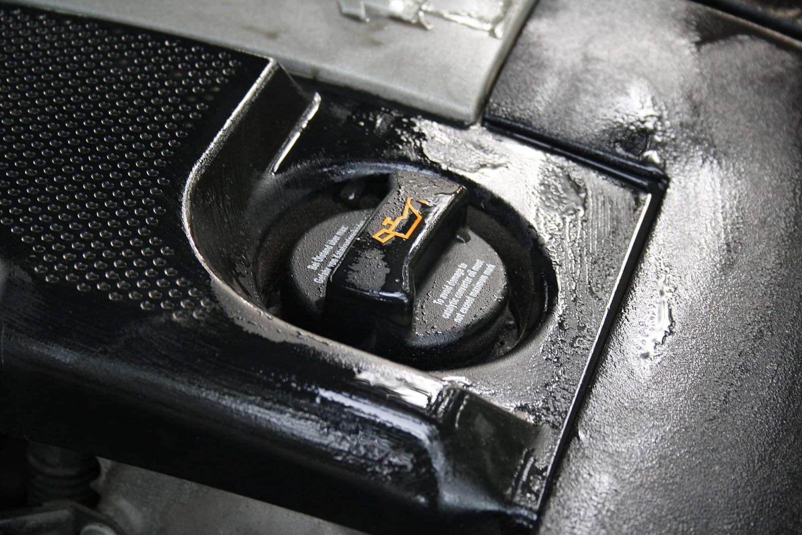 Oil filler cap opened for a one-litre top-up