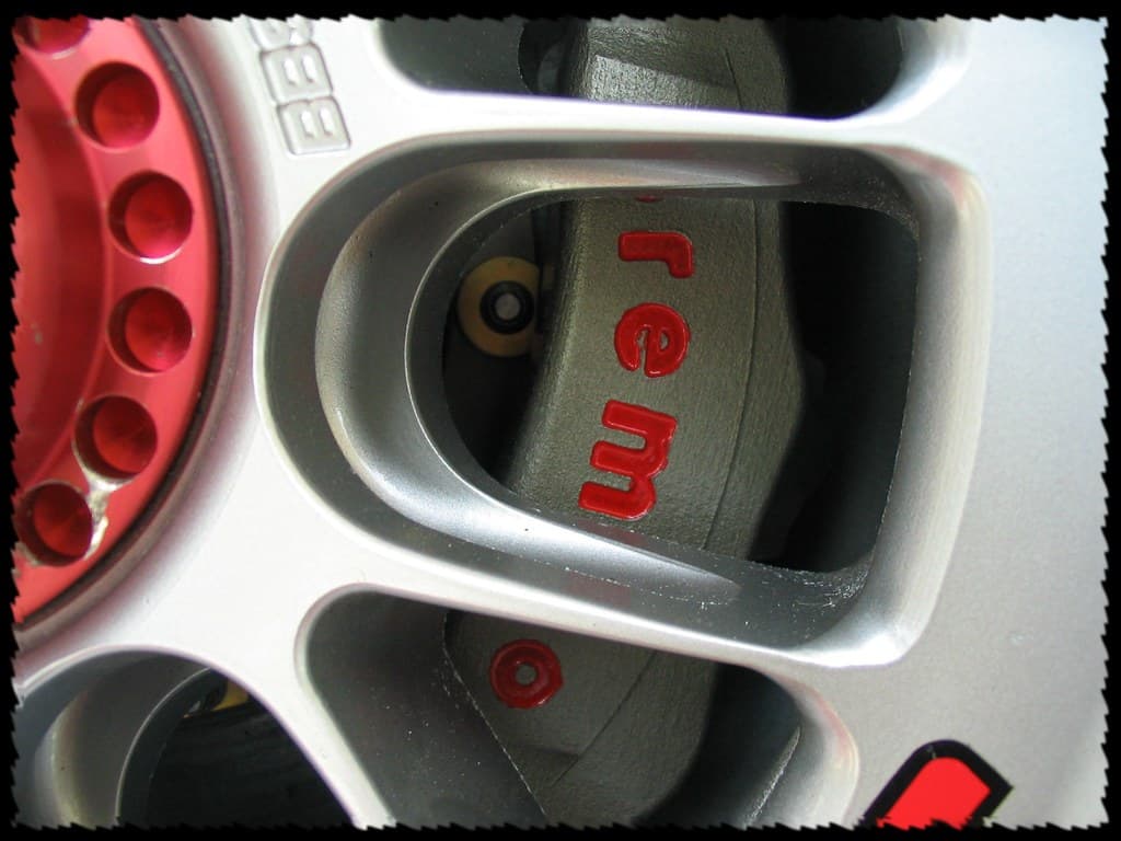 Cross-drilled Brembo disc and caliper seen through the spokes
