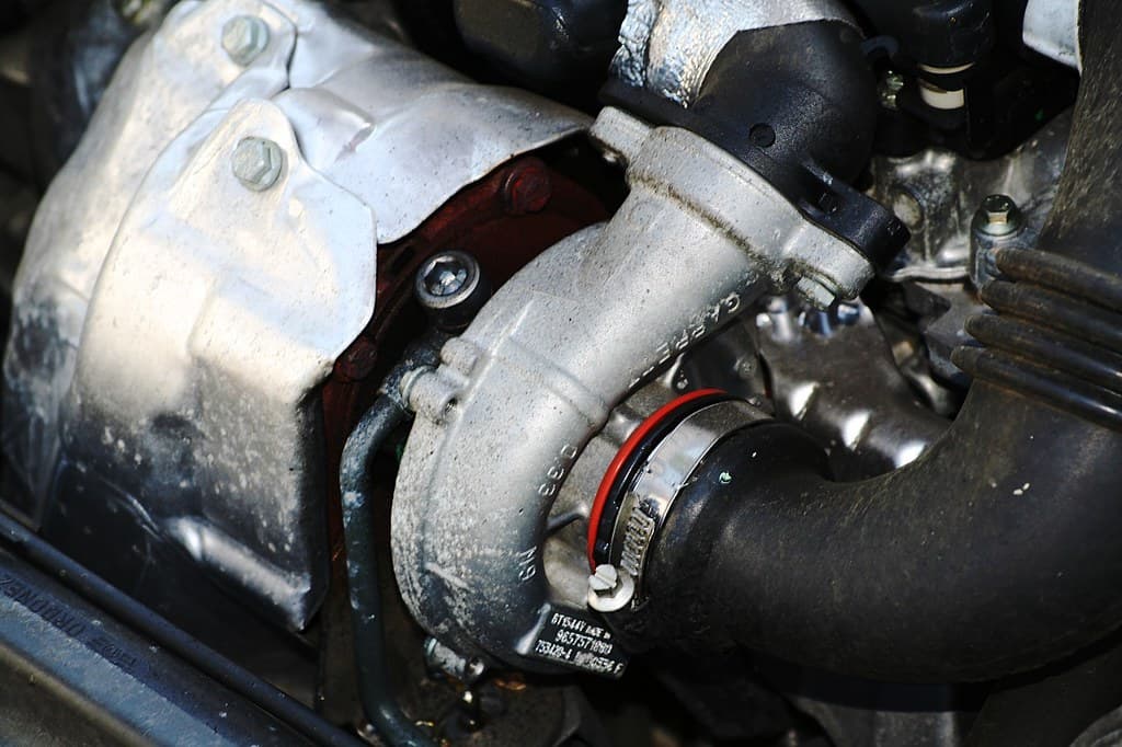 Turbocharger and charge piping the valve mounts to