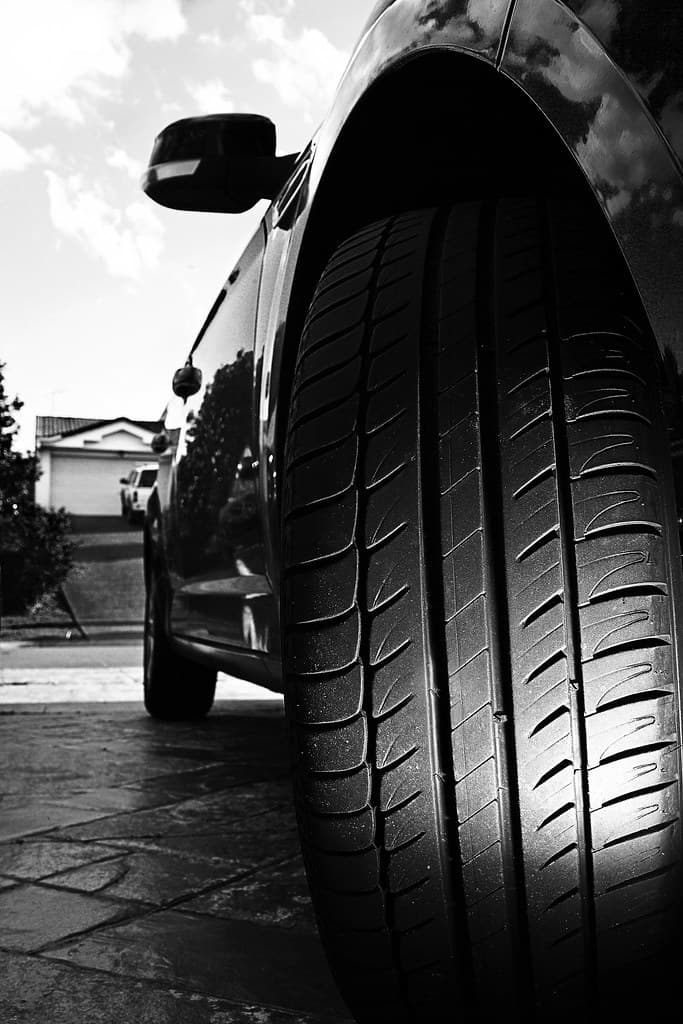 Track-derived tread with a near-solid outer shoulder